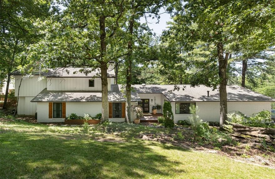 Beautiful Mt Sequoyah contemporary home in highly sought after Rockwood Subdivision. Completely renovated 4 Bedroom, 3 Bathroom home featuring brand new solid Maple wood floors in the living area. A new dual zoned 'Nest' controlled HVAC system, updated quartz counters, new oversized contemporary E windows, luxurious light fixtures, a huge walk-in closet with extra custom shoe closet, 2 fireplaces and a custom screened in porch (off the master) are some of the beautiful interior features this house has to offer. The outside of the house is surrounded by a massive wraparound deck with contemporary cedar posts along with a front patio and a backdoor sunken in courtyard designed for entertaining year-round. The oversized corner lot is heavily landscaped with trees and shrubs and frames this unique Mt Sequoyah home so elegantly. Within a very short walk to University of Arkansas and the entertainment district.