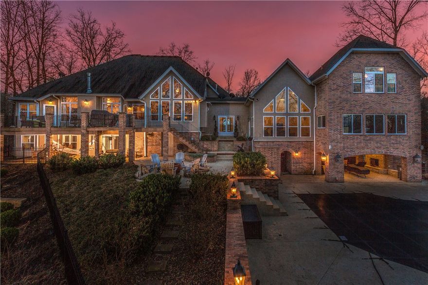 North Bentonville Gated Estate on 6 private acres! Stunning hill top views & a private backyard oasis w/ heated saltwater pool & huge covered outdoor living & entertaining area! High-end décor & updates throughout home. Multiple living areas & entertaining areas. 5 bedroom, 3 kitchens, 5 car garage. This one has it all!