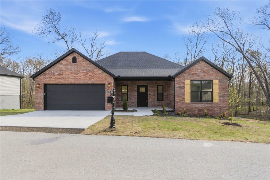 Quality new construction offering 4 bedrooms, 2 bathrooms sitting on a spacious 0.41-acre lot, minutes from Branchwood Recreation Center & close to Lake Loch Lomond. Located in the Highlands area of Bella Vista with easy access to I-49. Large granite island & an open-concept living area centered around a cozy ventless gas fireplace. The home is equipped with quality upgrades including blinds, gutters, and a hot water recirculation system. Garage is 100% insulated. Peaceful wooded views from an expansive back deck. 2 year builders warranty included! Please note: the home is served by a 3-bedroom septic system; the 4th bedroom is best suited as an office or flex space. Buyers are asked to acknowledge this with submission of an offer.
