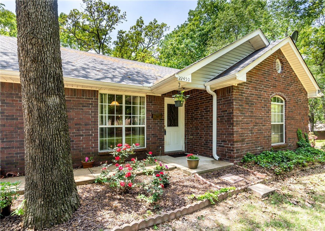 Located just outside of town on 2 lots! If you're looking for land to build a shop, this is the one. 2nd lot has no covenant restrictions. You'll find this 3 bedroom, 2.5 bath home with 1833sf of living space nestled amongst the trees. As you enter you'll notice the cathedral ceilings and natural light flowing. Galley-style kitchen with updated stainless appliances, a pantry & breakfast nook. Sunroom is currently being used as an in-home office. Newly placed laminate flooring & carpet with fresh paint throughout. 1/2 bath in the 2 car garage. Roof & gutters-2years old. 1.14 acres total-home with lot & additional lot that can be kept or built on (shop or home). One street outside of city limits, yet within minutes to everything. Being in the cul-de-sac provides seclusion & privacy from your back deck as you soak in the hot tub or gather with friends.