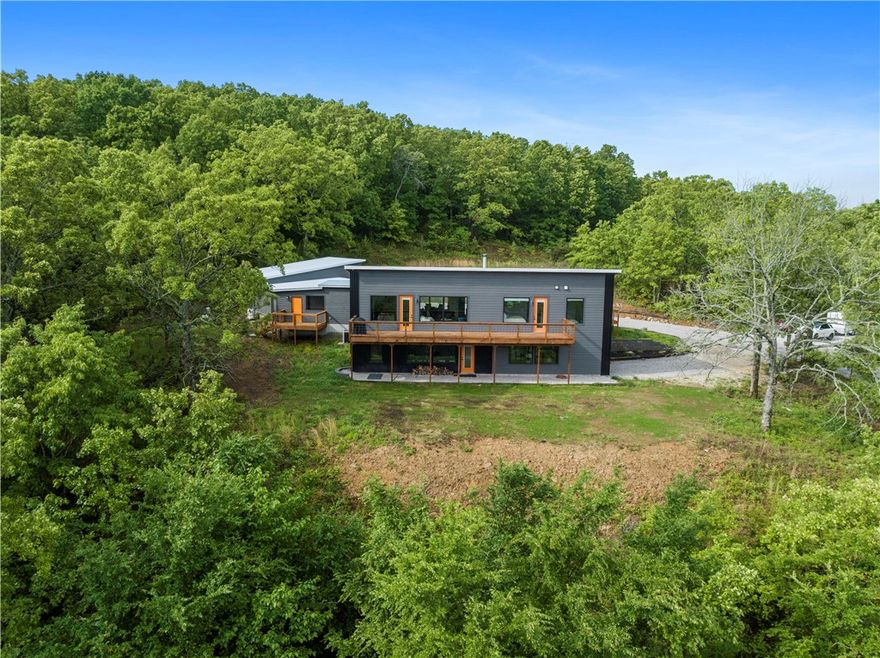 Modern Luxury Retreat - with Million Dollar Views. Indulge in  unparalleled sophistication with this custom-built luxury home, a true gem nestled on a gated 4.69-acre expanse of serene hillside. Every detail of this residence exudes elegance and opulence, offering a picturesque retreat with breathtaking valley views from the living spaces and expansive decks.New additions include a front deck office with a private entrance, a mudroom bathroom, and an impressive temperature-controlled garage featuring multiple stories, a loft, and a walk-in shower with dog attachments. Whether you seek to entertain lavishly or find peace in nature, this home offers an array of luxurious amenities to suit every lifestyle. 

Discover a wood-burning stove, a water filtration system, and numerous enhancements throughout. The large window gym provides a flexible living space.  Love the black Anderson windows!