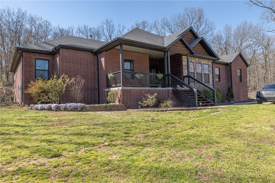 This modern ranch home in Hindsville is stunning. With 4 bedrooms & 2.5 baths, this well designed 2700 square feet sets on 2.10 acres, more or less,  in a prime and private NWA location. The open split floorpan offers stunning white oak flooring throughout (except bathrooms), oak cross beams and custom oak built ins. A wood stove insert will heat the home while adding ambience. Open to the living room is the spacious kitchen with gas cooktop, LG appliances, vent hood, coffee bar and the most incredible polished concrete countertops. The food pantry and butler's pantry/bar invite you to the nice dining room beaming with natural light. The primary bedroom suite has a first class bathroom with dual vanities, HUGE stand alone tub, shower, walk-in closet and private access to the vaulted/beamed back porch. Mudroom "locker". Work from home with OzarksGo Fiber internet & enjoy the surround sound. Above ground pool with deck. 1350 sqft shop with boat storage and work area. Wired for hot tub and 3rd garage mini split.