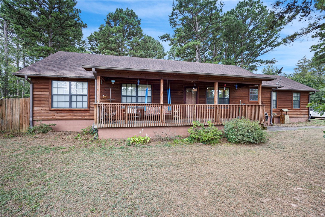 Look at this beautiful tree covered yard on a quiet dead end road just outside of town. This 1356 sqft 3 bedroom 2 bath home is just what you have been looking for. Enjoy the peacefulness of nature as you enjoy a cup of coffee on the front porch or enjoy an evening breeze. As you step inside you will love the living area with a vaulted ceiling and a fireplace to stay cozy beside on those cool evenings. The spacious kitchen and dining area provide room for family gatherings. The large fenced backyard gives plenty of room for kids and pets to enjoy running around in the shade.