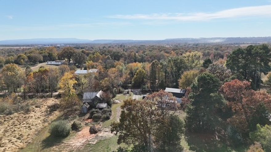 This 25.32 acres m/l is exactly what you have been looking for to build your dream home on! With lots of great home sites, water and electric meters on property, the getting-ready to build work has been done! Big trees, beautiful meadows, gorgeous pond, just lots of places to put that home on! This beautiful mini-farm site includes an old historic home that could be a cool project, Probably close to a hundred years old! Add an old well, a storm shelter, and you've got endless possibilities. Plus, and this is a huge plus, there is a 50X40 metal barn in great shape, with 18 foot overhangs on both sides! You'd have to work hard to fill up all of that space. Everything is in great shape on the barn, it's ready to be used!