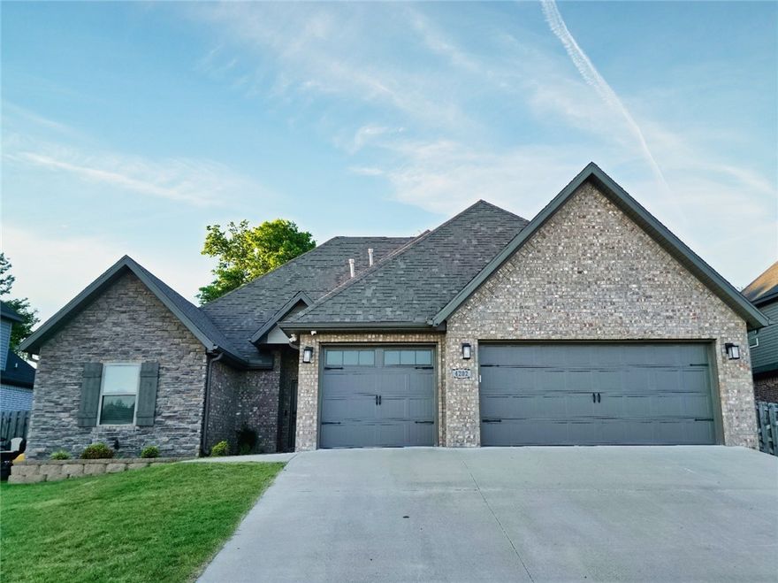 Nested among five mature trees in a quiet cul-de-sac, this stunning 6-bedroom, 4-bath home built in 2022 offers luxury living with a nature-inspired setting. Enjoy a spacious layout with a dedicated media room, an elegant remote-controlled fireplace, and a three-car garage. The home features two independent HVAC units, a French drain system, and perimeter landscaping with decorative stones. Included appliances: refrigerator, washer, dryer, microwave, oven, and dishwasher. The backyard includes a grill and play area. Lawn care is professionally maintained and prepaid through 2025, termite policy is active. Located just 0.1 miles from two dog parks, a community pool, a children's park, a scenic creek, and a walking trail. Zoned for Bentonville school district. Merely 15 mins from new Walmart home office. (Photos reflect the home when it was vacant and currently its tenant occupied).
