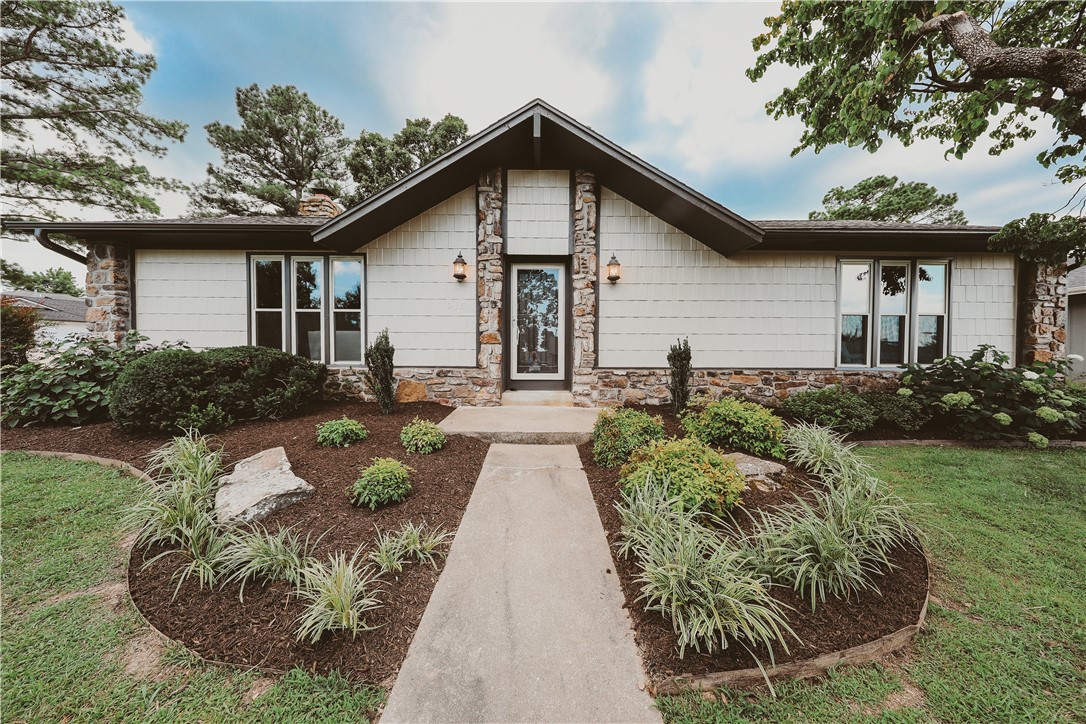This beautifully remodeled home sits on a spacious corner lot in a quiet cul-de-sac just off New Hope—minutes from I-49, the Promenade, AMP, & only a 5-minute walk to Dock Wheeler Park & Rogers Aquatic Park. Thoughtfully redesigned by Stone Harbor Custom Homes, every detail has been updated w/ care & fully permitted through City of Rogers. This home blends modern updates w/ timeless charm. Inside, enjoy luxury vinyl plank flooring throughout, fresh interior paint, dramatic floor-to-ceiling native rock gas fireplace that anchors the living room w/ warmth & character. The kitchen has been beautifully updated w/ new stainless steel appliances, granite, backsplash, bar area, modern lighting & hardware. Bathrooms have new sinks, toilets, fixtures, tile, & hardware, creating spa-like retreats. Additional new updates included: roof, HVAC unit, light fixtures, insulation,& fresh exterior paint. Outside, you’ll love the curb appeal w/ fresh landscaping & flower beds galore, 6x8 storage building, & a 2 car side load garage