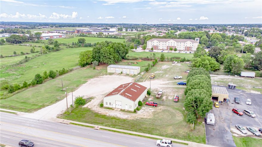 Prime large scale development opportunity just off the intersection of Highway 112 and US Highway 71 with 324 ft of road frontage. Current buildings are perfect for light industrial use - service garage or dealership, warehousing and shipping with some office space. Very flexible space with plenty of room for expansion. Plenty of room for parking trucks or light autos.