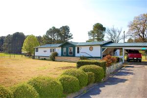 So many extras with this country home! Extra large living room. A cozy sun porch. Beautifully maintained pasture. Several outbuildings and carports. You will LOVE this kitchen! Many of the drawers and cabinets have custom built pull-outs maximizing storage and making it easy to find whatever you're looking for! This is the perfect place to have a flock of chickens or other livestock. Country life at it's finest. Don't miss out on this great opportunity. ''POSSIBLE OWNER FINANCING''