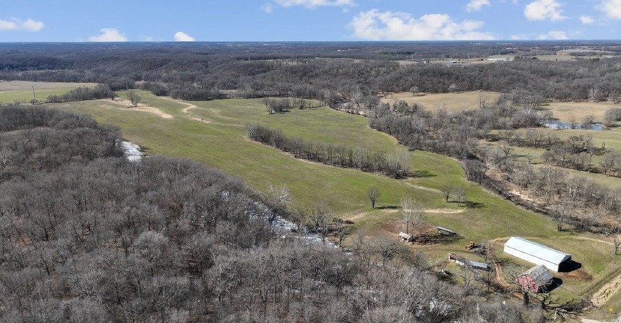 This land has 171 acres in Arkansas and 213 acres in Oklahoma. The land has one mile of frontage along Flint Creek. This land has substantial open pasture to run a cattle operation. It also offers abundant areas for hunting and fishing. It has great access to highway 43, while also offering privacy.