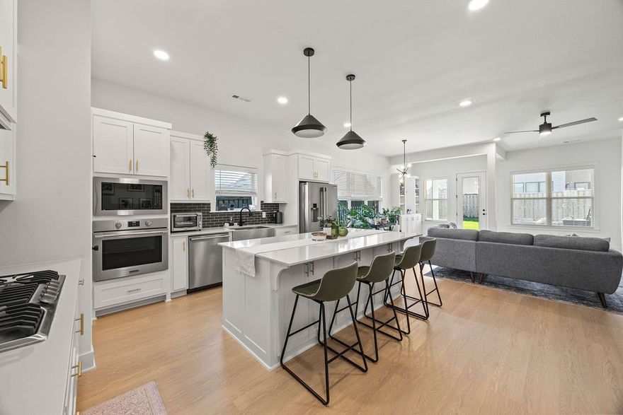 Beautiful single-level home on a CORNER LOT! Open-concept Living/Dining/Kitchen area is perfect for entertaining. The gourmet kitchen features quartz countertops, large island, gas range, & pantry. The living room is centered around a gas fireplace, while the dining area includes a built-in bar for added convenience. Primary suite w/en-suite bathroom features soaking tub, large walk-in shower, dual vanities, & walk-in closet. Two additional guest bedrooms share a full bath w/double vanity & tub/shower combo; separate guest suite includes its own attached bath. A half bath is also available for guests. Additional highlights include a large 2-car garage with built-ins, leading to a mudroom entry, & laundry room w/extra storage & counter space. Recent upgrades include professionally tinted windows for energy efficiency & LVP flooring throughout. Enjoy outdoor living in the spacious backyard with full privacy fencing and a covered patio — ideal for year-round enjoyment. Move-in ready and meticulously maintained.