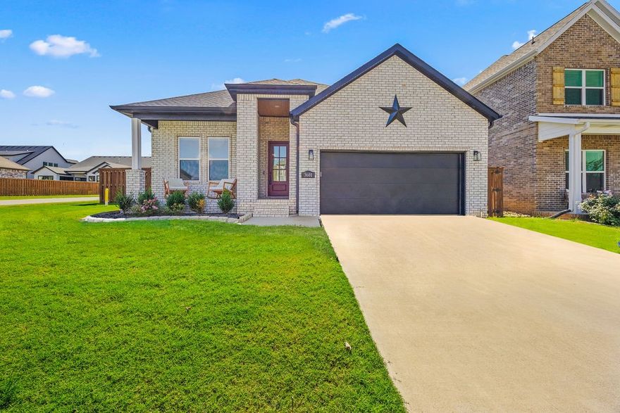Beautiful single-level home on a CORNER LOT! Open-concept Living/Dining/Kitchen area is perfect for entertaining. The gourmet kitchen features quartz countertops, large island, gas range, & pantry. The living room is centered around a gas fireplace, while the dining area includes a built-in bar for added convenience. Primary suite w/en-suite bathroom features soaking tub, large walk-in shower, dual vanities, & walk-in closet. Two additional guest bedrooms share a full bath w/double vanity & tub/shower combo; separate guest suite includes its own attached bath. A half bath is also available for guests. Additional highlights include a large 2-car garage with built-ins, leading to a mudroom entry, & laundry room w/extra storage & counter space. Recent upgrades include professionally tinted windows for energy efficiency & LVP flooring throughout. Enjoy outdoor living in the spacious backyard with full privacy fencing and a covered patio — ideal for year-round enjoyment. Move-in ready and meticulously maintained.