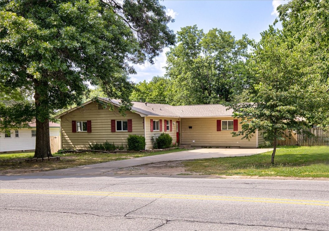 Take a look at this Charming home with 4BD/2BA, with a 25' by 26' workshop, laundry room, wood floors, and fireplace. Roof replaced in 2020. New Kitchen sink granite counter. Right next to Water Park, Pinacle Mall, Amp, downtown Rogers, The Rail Yard bike park, breweries, hospitals, grocery, entertainment, restaurants, retail, and all things NWA has to offer. Conveniently located with easy access to I-49. Washer and dryer convey. Friendly Dogs in backyard in cage, do not open it. Proffessional pictures to come.