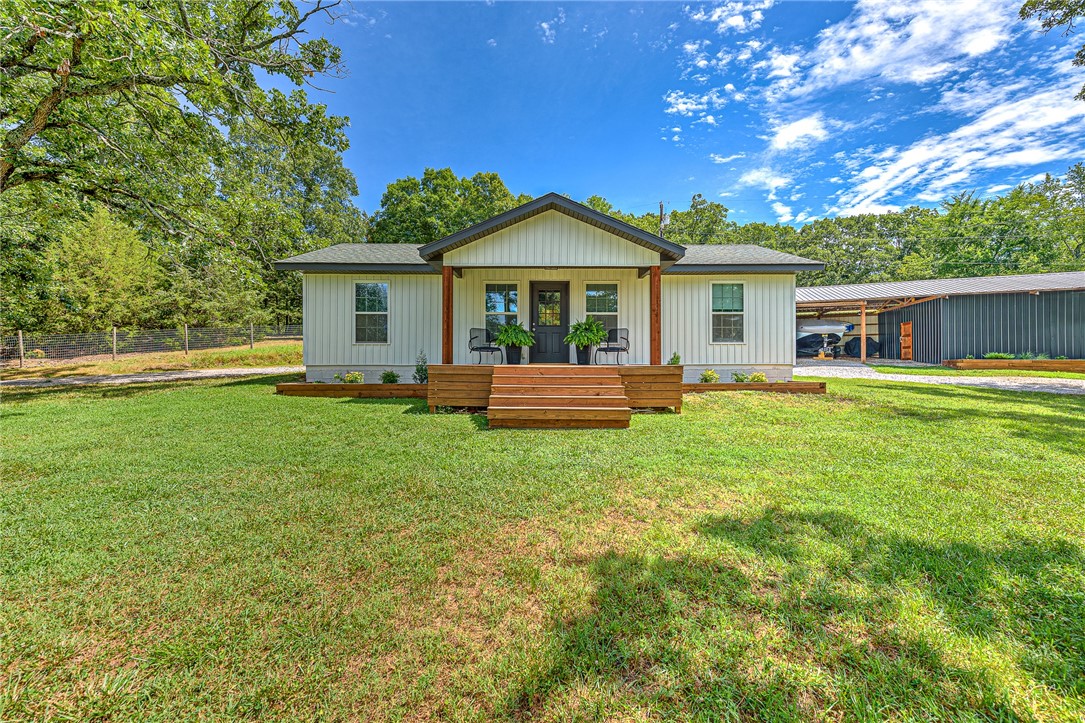 Searching for a hobby farm in NWA? This property is ideal for hobby farmers, outdoor enthusiasts, or anyone craving a little peace from the hustle & bustle. The home has 2 bedrooms, both w/ ensuite baths & ample storage. The updated 1640 sq ft pole barn includes an addt'l 400 sq ft of heated & cooled living space. Ideal for a studio, office, or guest quarters. The barn has an animal pen, workshop area, & covered storage for your boat or farm equipment. You'll love the newly painted exterior & interior, stylish LVP flooring, updated lighting, & modernized front porch for added curb appeal. Don't miss the whimsical well house—a dreamy little escape that’s been transformed into the ultimate hideout. Enjoy fishing in the pond (pond is shared w/ a neighbor). The addt'l land across the road, provides a potential future building site or the ultimate garden. Zoned for Vandergriff Elementary too. Whether you're looking to start a mini homestead or just want a little slice of serenity, this unique property offers it all!