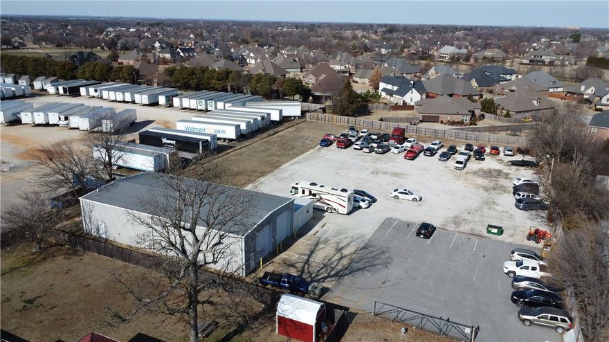 3,600+/- Sq ft red iron built warehouse with 1.34+/- acre lot just off I49 and convenient to everything NWA. Approximately 3,200 Sq Ft of warehouse space with half bath and dual 14' garage doors. ( tall enough for semi/dump truck/RV etc) There is 400 sq ft of office space with mini split. Tons of concrete/asphalt parking and gravel parking. Lockable entrance gate and high fencing around the entire property. Multiple possibilities for intended use. Zoned C5