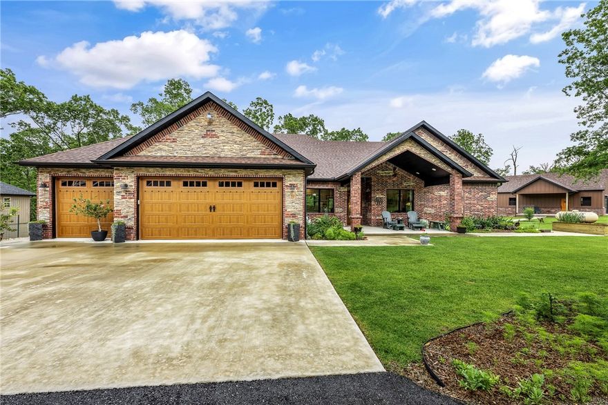 Immaculate Custom Home on 0.79 acres is 2511 sqft with 10' ceilings, engineered hardwoods, and handpicked designer touches throughout. The chef’s kitchen boasts custom cabinets, granite countertops, pot filler, high-end KitchenAid appliances, and a HUGE island with storage on both sides. A MASSIVE walk-in pantry with barn door adds function and style. Two luxurious owner’s suites offer large tiled walk-in showers and double vanities. Master 1 includes a huge 10' x 28' closet with movable island that would make the Kardashians jealous :). Pella black windows frame beautiful views of the fully sodded, meticulously landscaped yard and 12' x 46' back deck overlooking the BEAUTY. A concrete walkway leads to the brand-new, heated/cooled custom shop, 1004 sqft with 220 electric throughout. Over-sized three car garage and shop make BIG Trucks & Boat storage a breeze. Minutes from I-49, Highlands Golf Course, Loch Lomond, and a short drive to Walmart Home Office. Includes 3 parcels for added space and privacy.