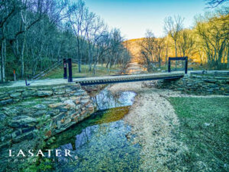 Amazing opportunity to own a private retreat or rental business with an amazing Amphitheatre made from natural stone. Gorgeous 40 acres on Smith Hollow with year-round Brush Creek. Includes three cabins, maintenance building and one Colorado Yurt. There is a 96-foot-long awe-inspiring engineered suspension bridge over the year-round creek designed by an engineer who built bridges for the Nature Conservancy which is possibly the longest privately owned suspension bridge in AR. Located 3.8 from Marshall and U.S. Hwy 65. Property also offers a year-round spring, a drilled well and lots of room for expansion. It also offers some nice views and lots of activities in the area. Buffalo National River, Blanchard Springs, Mirror Lake, Mtn. View, White River, several lakes, Jasper, and Branson, MO.
