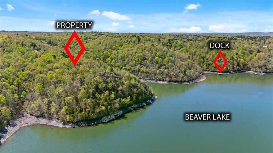 Discover a rare opportunity to own 23.26 acres of waterfront on it's own peninsula, including one slip in a 2-slip co-owned boat dock, on Beaver Lake. This remarkable tract of two parcels boasts 1,386 ft of corp/shoreline, offering breathtaking water views, exceptional privacy, and endless potential. The property showcases an abundance of native wildlife, mature trees, and striking limestone bluffs at the water’s edge, creating a truly picturesque Ozark setting. A well-established dirt road runs through the property to the tip of the point - one of the finest build sites on the lake – an elevated perch where a future residence would be embraced by open water on 3 sides. A secondary road leads down the hillside to the shoreline. Two easements lead down to your boat slip, providing convenient lake access. Enjoy peaceful seclusion just minutes from modern convenience. Rarely does a property of this size, setting, and lake frontage become available—secure your piece of Northwest Arkansas lakefront paradise today.