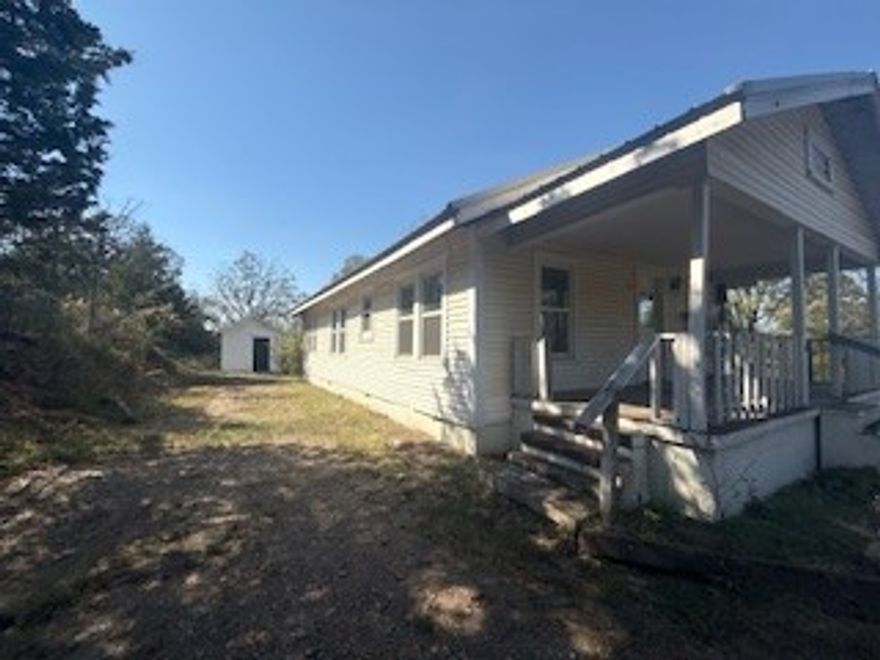 Newly listed is this updated and secluded 3 bed,1 bath 1075 sft +/- country country home sitting on 2.98 acres +/- with mountain views.  Newer flooring, paint, sheetrock, lighting, kitchen w/butcher block counters and bath all done in 2024-2025. New front porch stairs installed in December of 2025. Comes with a storage building/workshop. Has an open concept living/dining area. Sit and enjoy the evening on the covered porch. Just a ½ mile to a public Arkansas River Boat Launch, minutes from Subiaco Abbey, breweries, and Paris for shopping, medical and food. Call for your showing today!