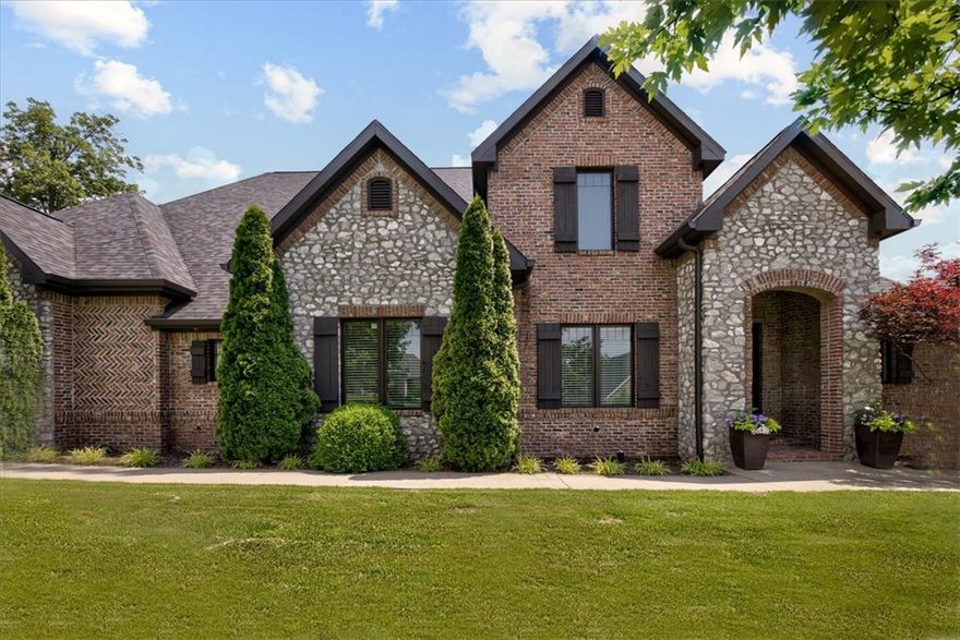 STUNNING and immaculate one-owner home in gated Heritage Hills Subdivision! Loaded with amenities and quality! Open floor plan with tons of light and chef's Kitchen opens to fabulous Living Room. Kitchen has beautiful white cabinets with quartz countertops, and large granite island with bar. Breakfast Room. Living Room with high ceilings, and beautiful fireplace. Wonderful Owner's Suite with beamed ceiling. Hardwood floors in Kitchen, Breakfast Room, Living Room, Formal LR/Office, and hallways. Additional bedroom and 2 full baths all on the main level. Second level features 3 bedrooms, 2 full baths (One Jack and Jill Bath), plus an ample Bonus Room. Relax in your backyard with your large covered patio with brick fireplace, professional landscaping, fencing, and fire pit. Great location with easy access to shopping, restaurants, and schools. Don't miss this amazing property!!