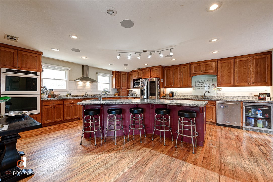 Directly across the street from the Donald W Reynolds Razorback football stadium, this iconic game-day destination is known & loved by all! Remodeled and expanded in 2013, this 7 bedroom/6 bath home with 2 kitchens, a 42’x25’ game/media room, and a total of 3 ensuites is an entertainer’s dream! The beautifully-landscaped yard is wired w/electric & cable, and even the 2-story treehouse is equipped w/TV mounts, electric, & WiFi. Northwest Arkansas, ranked one of the Best Places to Live in America, is home to university & professional sports teams, world-class Crystal Bridges Museum of American Art, more than 200 miles of mountain biking and paved trails, & headquarters for Walmart, Tyson Foods, & JB Hunt. Two home businesses to convey at seller’s discretion. Driveway is shared with 400 N Oliver.