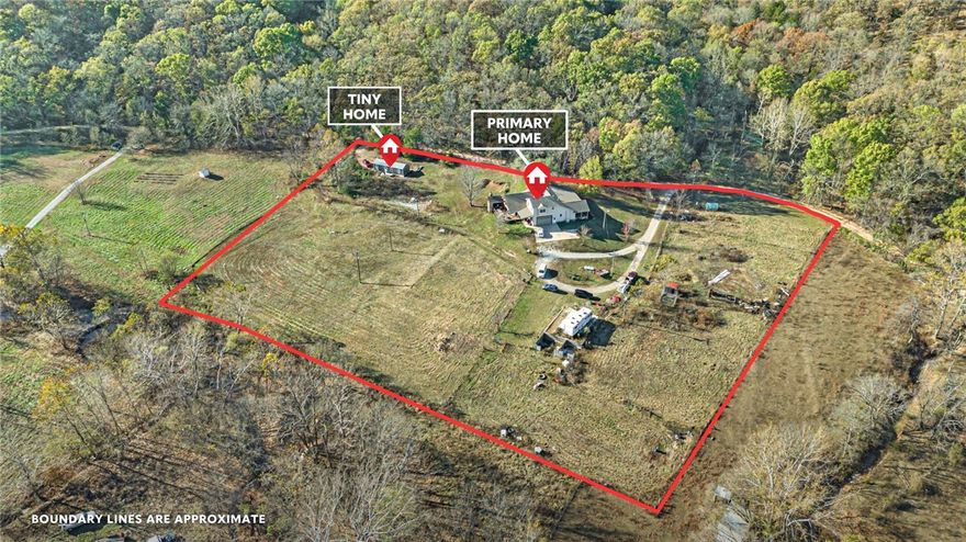 Looking for country living with a view? This 5-acre property, situated near rolling hills & a peaceful creek, includes a main house & a tiny home. With over 3,000 sqft of living space, the inside of the main home features a modernized interior that's newly painted with two primary suites (one on main level & one upstairs), a split floorplan for optimal privacy, & a dedicated office or hobby room. Large living area complete with a pellet stove & two skylights. The eat-in kitchen has plenty of cabinetry storage & stainless-steel appliances with an upgraded gas stove. Adjacent to the kitchen is a sunroom that could double as extra living space- featuring soaring ceilings, beautiful beams, & abundant natural light with access to two covered patios. Expansive covered patio with a fireplace & outdoor kitchen, ideal for entertaining! From the big patio, take the spiral stairs to a bonus hangout area. 2-car attached garage. 600 sqft tiny home includes a kitchen, living room, & bedroom/bathroom with laundry area.