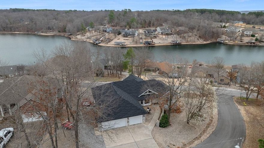 Beautifully renovated home with outstanding lake views in Bella Vista. This 3-bedroom split floor plan includes a dedicated office plus a heated/cooled basement flex room with private entrance—perfect for a guest suite, studio, or home gym. Basement is 233sqft not included in overall square footage! The standout sunroom features wall-to-wall windows showcasing stunning views of Lake Loch Lomond and filling the home with natural light. Primary suite has a walk-in closet and huge jacuzzi tub and radiant heater in the primary bath. Kitchen features flush quartz countertop island, farm sink, and large walk-in pantry - spacious enough for everything! Fully renovated top to bottom in Fall 2023 complete with new appliances, new light fixtures and fans, fresh paint, LVP flooring throughout, and quartz countertops in the kitchen, laundry room, and both bathrooms. Major updates also include a new roof and gutters (2023). Spacious 2.5-car garage and only the second owner.