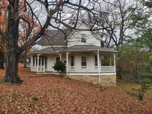 Picturesque Victorian home in the heart of Harrison. This charming 1 1/2 story home can be used as 2 or 3 bedrooms, 1 1/2 baths with many great features. Take in the open beam ceilings, and warm yourself by the double sided gas fireplace, or sit on the open or screened in porch to enjoy the morning coffee and enjoy the large lot with fenced back yard and large shade trees!