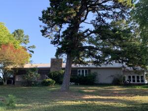This charming 3 bedroom, 2 bath home has beautiful mountain views and sits atop the hill overlooking Ola. Enjoy a large 2.2 acre lot with mature pecan and pine trees in the front yard. There is a well house for the garden while having city water to the home. Cozy up to the wood burning fireplace in the primary bedroom and enjoy the views from the beautiful deck. Schedule an appointment to see what all this home has to offer!