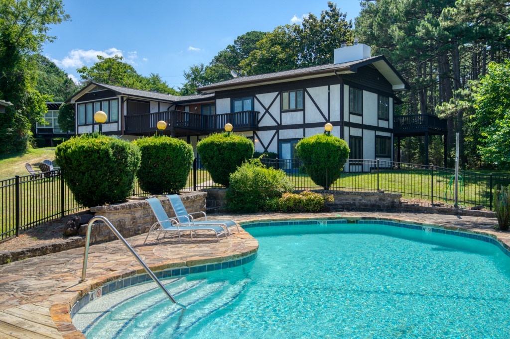 This amazing home, salt-water pool, and guest house have the privacy of being in the country while being only a matter of feet from Highway 62 inside of Eureka Springs! This ultra-convenient location is zoned C-2 and could be operated as a nightly rental lodging or other business. The main and guest houses combine to provide over 4000 square feet on the 5.7 acres. The house is equipped with a very large master suite, kitchen with āboothā seating, formal dining room, sunken living room with fireplace, sunroom, 2 decks, hot tub/game room with wood stove, 2 car garage, goldfish pond, and central vacuum. The pool itself is the picture of relaxation with its cabana, full bathroom, storage areas for toys, and a full fence for safety. This unique property would work equally well as your private estate or as a business!