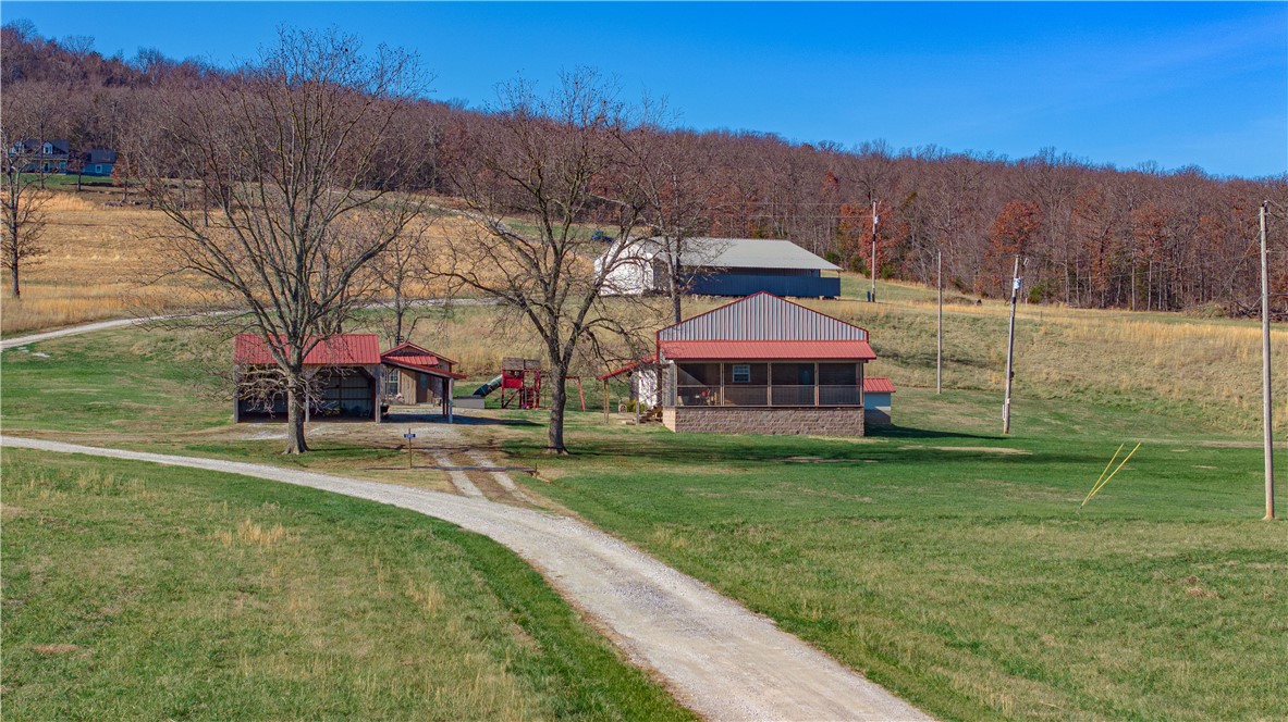 This could be your "Rural Bliss". Wide open spaces, mountain views, and tranquil surroundings are the only way to describe this charming home. The screened-in front porch views and tucked away screened-in patio are perfect for un-winding. Well maintained home with a separate studio 463 sf with a mini-split, great for a hobby room or office. Metal shop, located behind the home is 2400 sf with 12x60 lean to. Wood burning stove, loft, lift, shelving and 220 V are some of the many perks the shop has to offer. One drilled well located by studio and one hand dug on the rear patio. Seller Motivated, Bring your Offer!