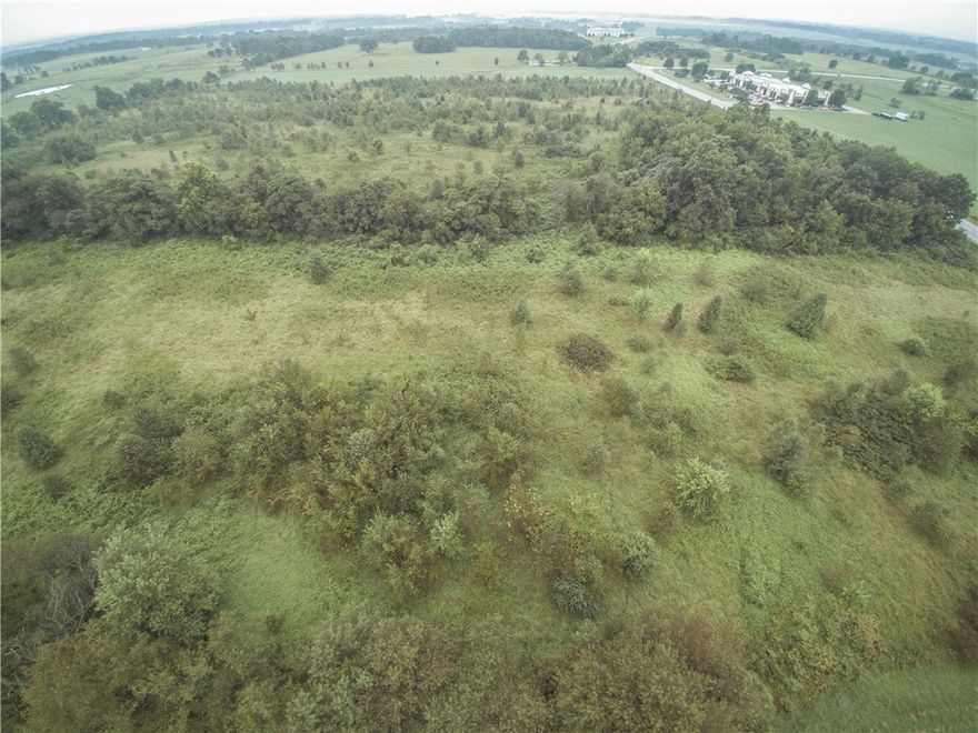 DEVELOPMENT POTENTIAL. Close to XNA airport and Bentonville. Approximately 950 ft of road frontage on Regional Airport Blvd. on HWY 12 East. Located across from Polo Park Business Campus.  Great Location for most any development. Very flat level property with all utilities located at road.