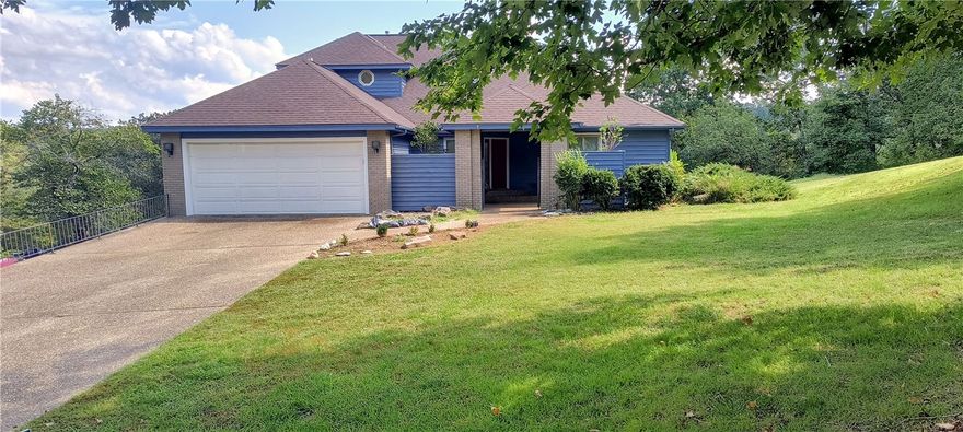 Location is everything, only five minutes from downtown Rogers. Lakefront home in nice oversize lot. Beautiful views of Lake Atalanta. This home has a huge deck and great lower-level room for anything you would like to do, a gym, or media room, or library, etc... There is a walking path down to the lake side to sightseeing, fishing, or just walking your doggie. This home is well maintained and is in move-in-ready condition. It's difficult to find such a nice lakefront home anywhere in NWA in this price range. See for yourself! HVAC system and water heater two years old, roofing five years old. Call-Text-Email with any questions, Thanks much!