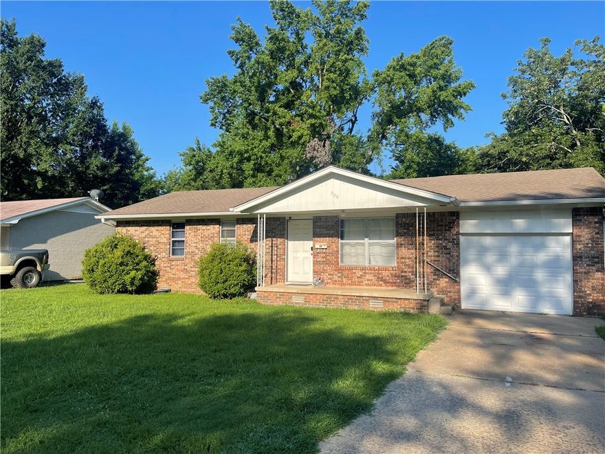 This charming brick dwelling offers a convenient location, fenced back lawn, and extra parking pad. Ready for that new home, schedule a showing now!  Delightful kitchen offers a very nice gas range and plenty of countertop space. Living room has ample space and lots of windows. One level and adorable, easy to maintain.  Back yard is large with mature shade trees and a cute pebble stone patio!