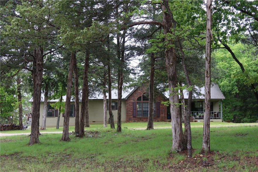 Here is your chance to wake up to a gorgeous view of Beaver lake with a gentle slope to 250 feet of shoreline on 2.00 acres of serenity. This custom built home has a large living room with cathedral ceilings, wood flooring, wood burning fireplace, 3 bed, 2 bath, split floor plan, oversized insulated 2 car garage with a receptacle for RV, and a large deck that overlooks the lake. Updates include new roof 2025, furnace 2025, patio doors 2025, toilets 2024, sinks/faucets 2018, hot water heater 2018, appliances 2018, countertops 2018, paint exterior 2018, interior paint 2024, carpet 2018. Property is located just a few minutes from Rocky Branch marina.  This property also has an unfinished guest house with approximately 1,000 square feet.  It is wired, plumbed, sheetrocked and has a new roof in 2025.  Don't miss this incredible opportunity to live on the lake.