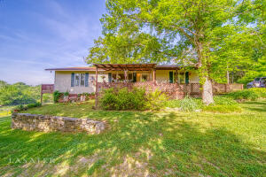 This is your Pleasant Valley Farm in the Ozark Mtns. Less than 5 minutes to Walmart and only 2/10 gravel road. These 40 acres and a home are country living at it's best! Home has updated hardwoods, tile, and new trim. Covered front porch to enjoy a peaceful rainy morning and a deck off the large master suite. The unfinished basement can be a garage for your vehicle and workshop for the handi-person of the family. There are 2 ponds, spring, wet weather stream, a barn, chicken coop, 220 outlet for your camper. See documents tab for additional features.