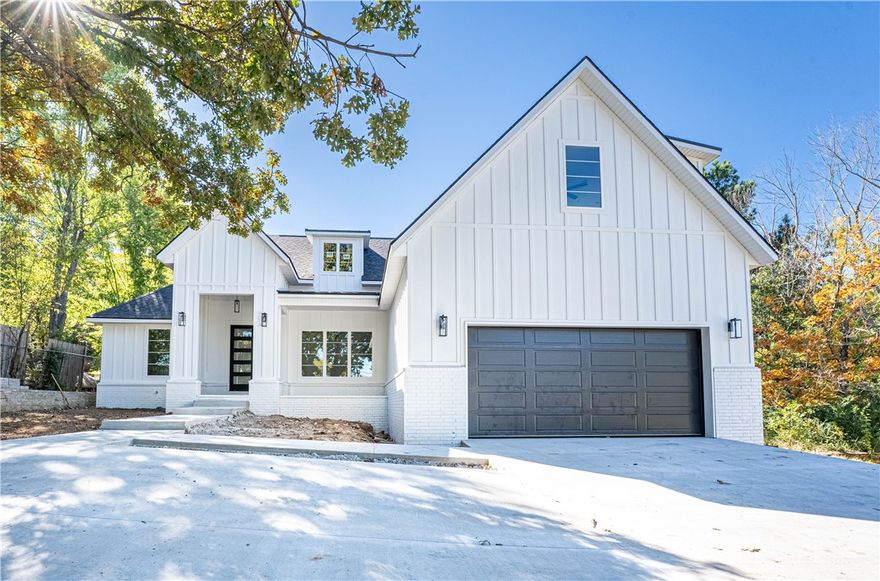 Stunning New Construction home close to everything in Fayetteville. Natural light pours in through the spacious living room with a lovely fireplace framed by built-in's and floating shelves. Gorgeous kitchen with a large island for entertaining. Split floor plan with a spacious primary suite. Primary bathroom with a free standing tub and custom tile shower. Large primary walk-in closet that leads to the laundry room. Custom cabinetry & woodwork with a mixture of Quartz and Granite countertops throughout the home. Beautiful modern light fixtures and cabinet hardware. Smart thermostat for energy efficiency. The exterior has covered deck & attached 2 car garage with 3 more parking spaces in the drive way.