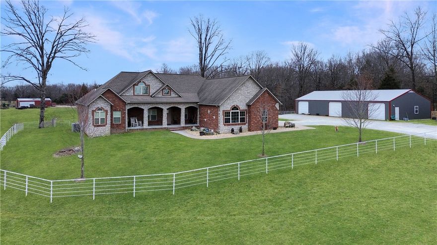 Properties like this don’t come around often! This executive-style home offers 2,607 sq ft of thoughtfully designed living space, featuring 3 bedrooms, 2.5 baths, plus an office and a beautiful sunroom. The large primary suite is a standout, with a spacious bedroom, luxurious bath, and an oversized walk-in closet. High-end finishes include real hardwood floors, vaulted ceilings, granite countertops, and an on-demand hot water heater, all wrapped in a low-maintenance brick and stone exterior.
Outside, 46 manicured acres provide the perfect blend of open space and usability. Need a place to store your vehicles, equipment, or recreational toys? The 36x70 shop with three garage doors, a 60x30 open-sided shed, and a 25x60 hay barn offer plenty of storage. With over 3,000 feet of pipe fencing, four ponds, 400' well with new pump and natural gas available along Cottonwood Rd, this property is ready to impress.
Don’t miss your chance to own this stunning property just outside the city limits—schedule your showing today!