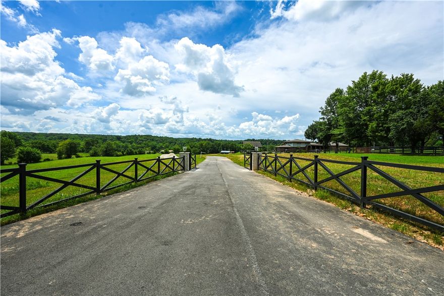 Are you dreaming of living in a community with a neighborhood feel but also have some space? Build your dream home on this almost 10-acre premier estate lot located in one of NWA's most coveted areas. This exceptional lot offers the ultimate in luxury, privacy, and convenience. Located on a private, gated drive only 3 min from 112, 6 min from I-49, and 7 min to 412, this lots offers easy access to major routes, making commuting a breeze while still providing a peaceful retreat from the hustle and bustle. Nestled in a distinguished area known for its beauty and luxury homes, this location is just 5 minutes from the Blessings Golf Club and backs up to Clear Creek. This 9.96 acre lot allows for ample space while enjoying the benefits of a family-friendly neighborhood. Additional acreage available. *House is for inspiration purposes only.