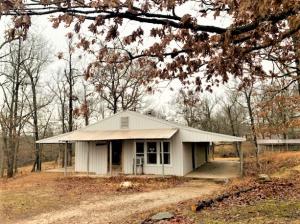 Lots of potential here! Great location on the outskirts of Harrison, paved road, fenced,cross fenced and has gates for all openings. 4.56 acres with scattered trees and metal house that need finished. With a little work this will be a very nice place. 2 bedrooms plus office, or could be 3 bedroom. Sq footage and room sizes are approximate. Will not qualify for RD, VA or FHA loan.