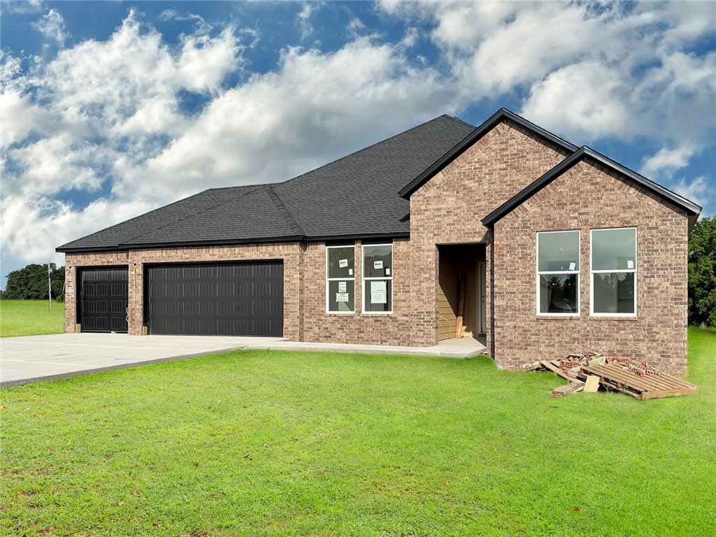 Gorgeous Garland plan with a 3-car garage in Monitor Meadows, where you'll experience modern luxury in Lowell, Arkansas. Our meticulously crafted floor plans provide ample space for you to grow and thrive. Bedroom 1 will have a fan and your fabulous ensuite will have an oversized walk-in shower, elongated commode and quartz counters. You'll find fantastic quartz counter tops also in the kitchen with tile backsplash and 42-inch upper cabinets. Black plumbing fixtures throughout! LED lighting throughout! Living room will have a fan and a modern electric fireplace with a poplar mantle.