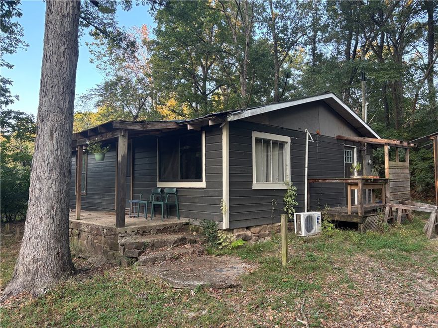Don't miss this charming property in a great location with an affordable price point! The 918 sqft traditional home has 2br/1ba, open living area with vaulted ceiling, all newer appliances that convey. The covered front porch overlooks a nicely shaded yard, 18x20 metal shed for parking just outside the kitchen door. Find additional bonus space and possibilities in the 240 sqft A-frame nestled nearby. Minutes to all the amenities, 10 minutes to U of A campus, Farmington school district. Sold As-Is, no repairs. Call to schedule your showing!