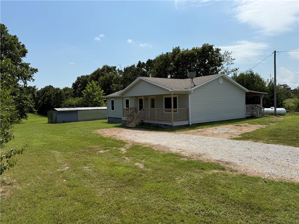 Come home to the peace and quiet of the country. Home features 3 bedrooms with 2 baths, open kitchen and living area, and a wood burning stove for those cold winter nights. Large covered porch provides a perfect place to relax! Don't miss out on the opportunity to move to the country that's still close enough to enjoy the amenities of the city. Home has new windows, bath sink and toilet. Roof was recently inspected and deemed to be in good condition.