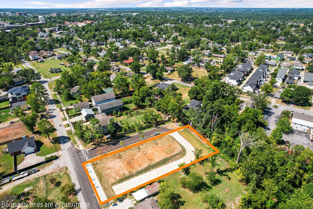 Ready for your development. Made up of 4 building lots, driveway and sidewalk already paved. Located directly behind Crystal Bridges and a 1/2 mile to the Downtown Square. Hop on the Zeppelin multi-use trail right from the property to ride the Slaughter Pen trail system and beyond.