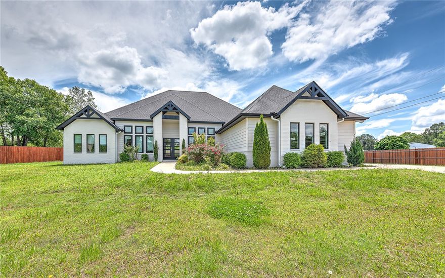 This like-new, one-level home in desirable East Fayetteville offers modern living on a large, private lot. Featuring a split floor plan, the home boasts a spacious open concept living area and a versatile flex space that can serve as an office, library, or playroom. The primary suite is a true retreat, with a luxurious large walk-in shower and soaking tub for ultimate relaxation. Upgraded features throughout the home include electric window coverings, designer wallpaper and much more. Step outside to your extended back patio with added fencing and recent tree plantings, for added privacy - making the perfect spot for entertaining or relaxing. Providing energy efficiency, there's a a solar-powered driveway entrance and the garage is equipped with an EV charging station. Don’t miss your chance to make this gem your own!