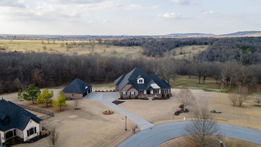 This one owner custom built home close to everything Fayetteville has to offer located on 6.35 acres in Grand Valley Estates (a gated community). It is just waiting for you to call home. This home boasts 5,359 sf, 4 bedrooms, 4 full baths, 3 half baths. Soaring ceilings of 12 ft makes it feel spacious. This open floor plan is to die for with gourmet kitchen perfect for any cook and entertainer. The views from the expansive doors leading out to a composite floored deck are spectacular. Stunning lower level features 10 foot ceilings with walk out patio with beautiful views. This home also has an oversized attached 3 car garage with tall ceilings and offers a 1,364-sf detached garage/shop with bathroom and 425 sf of storage. The possibilities for this structure are endless. The property is in a great location to all of NWA. This home is a must see to appreciate.