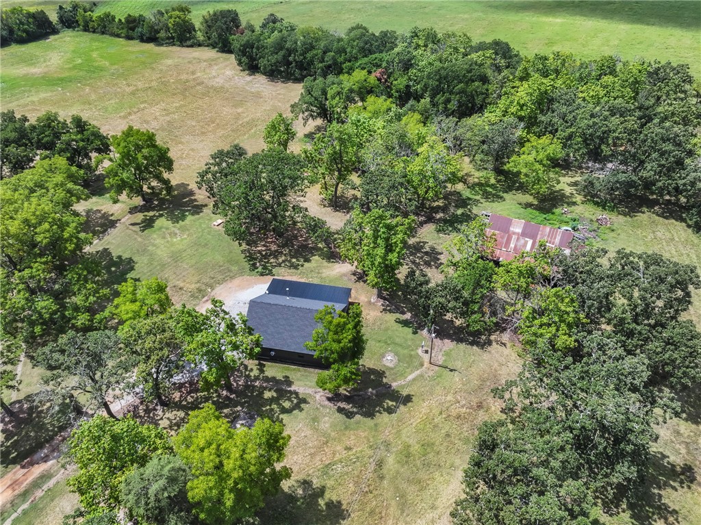 Escape to the country w/this 25.97acre property offering wide-open space, gorgeous views, & endless potential. Mostly flat & open, the land is fully fenced & features a tranquil pond, making it ideal for livestock, or simply enjoying the peaceful setting. At the heart of the property is a 2,025 sq. ft. shop w/a 1 bed1bath living space,& currently being used as a home w/kitchen & open living space. This versatile building can remain as a home, or it can be a shop w/living quarters. Additional features include rural water, an RV hookup, & a large old barn that adds character & storage options, w/potential for restoration. This property is truly unique offering privacy, quiet country living,& flexibility for a variety of uses. Whether you’re looking for a hobby farm, a place to build your forever home, or simply a retreat w/room to grow, this acreage provides the perfect canvas.