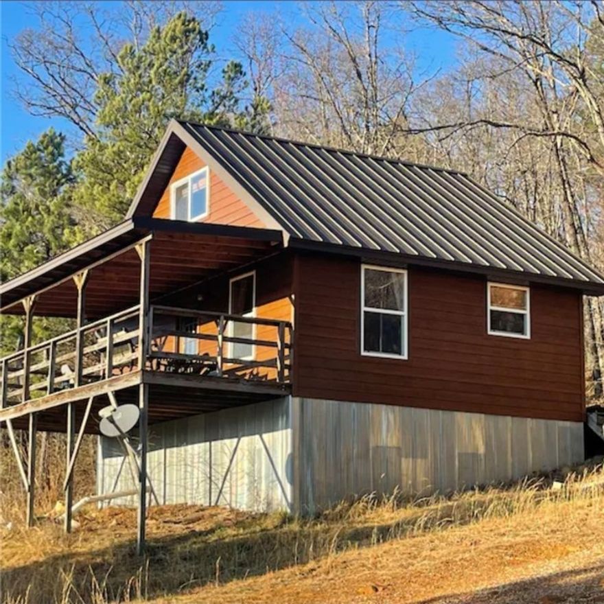 Charming 1-Bedroom Cabin Overlooking Horseshoe Canyon Ranch. Enjoy the best of Newton County in this 1,000 sq. ft., two-story cabin ideally located between Kyles Landing and Steel Creek, two of the most popular access points to the Buffalo National River. The property overlooks the western bluff of Horseshoe Canyon Ranch, offering stunning views and quick access to rock climbing, hiking, mountain biking, and floating. This inviting cabin features 1 bedroom, 1 bathroom, a full-size kitchen, and a laundry room. The open layout and large windows bring in natural light while showcasing the surrounding Ozark scenery. Enjoy peaceful mornings on the porch and relaxing evenings after a day of adventure in the Buffalo River area. Perfect for use as a vacation home, nightly rental investment, or full-time residence.
