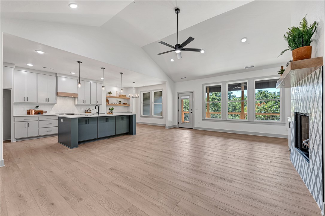 Stunning Modern Luxury Home with Breathtaking Ozark Views! Welcome to this exceptional single-story home, perfectly nestled on nearly 1/2 an acre w/ serene views. Designed w/ elegance & functionality in mind. Soaring cathedral ceilings & premium finishes throughout—no detail has been overlooked & no expense spared. Step inside to find Luxury Vinyl Plank flooring that flows seamlessly across the spacious layout. The great room is filled w/ natural light from oversized windows that showcase the beautiful Ozarks. The kitchen is an entertainer’s dream, featuring a massive island, quartz, custom cabinetry & walk-in pantry. 3 bdrms, 2.5 bthrms, + an Office w/ built-ins. The primary suite is tucked away in it's own private wing; spa-like bathroom w/ a soaking tub & custom shower w/ full tile accent wall. Enjoy a large covered deck perfect for relaxing or entertaining. Oversized two-car garage. This home truly has it all: style, comfort, & views. Don’t miss your chance to own this one-of-a-kind retreat!