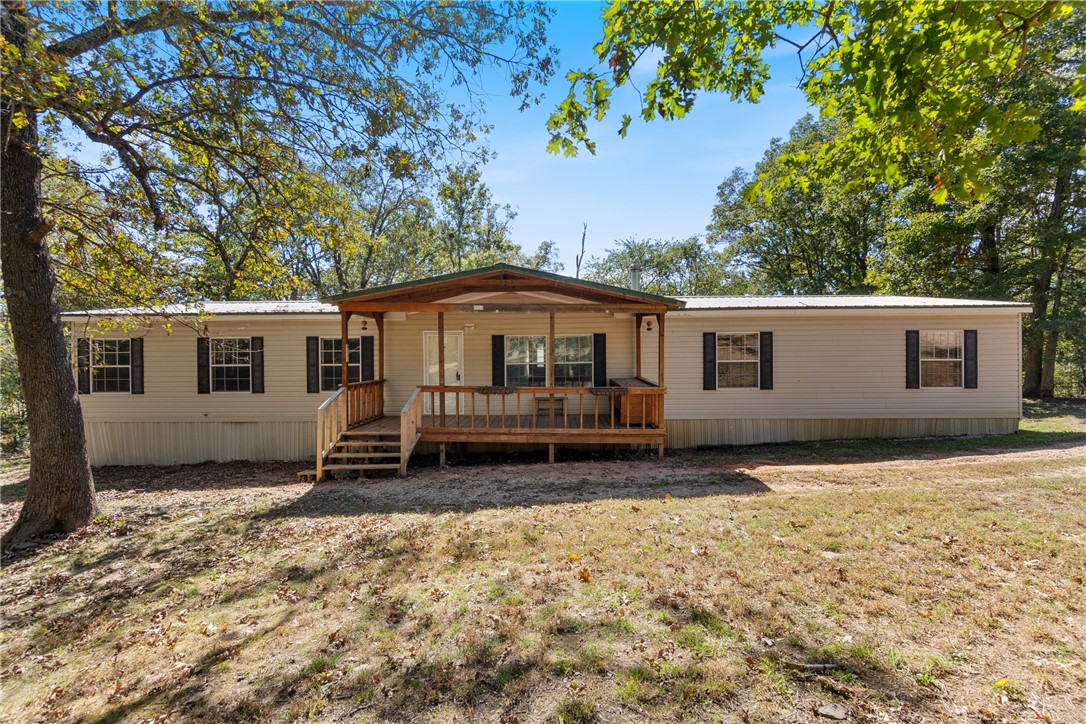 Welcome to 21577 Fern Rd — a peaceful country retreat just minutes from Elkins! This 3 bedroom, 2 bath mobile home sits on 2.5 acres, offering space to breathe and enjoy the outdoors. Relax on the covered front porch or entertain on the back deck overlooking a fenced yard, perfect for pets or play. Inside, you’ll find two inviting living areas — one featuring a cozy wood-burning stove and the other a wood-burning fireplace, creating warmth and charm throughout. The spacious primary suite includes a large walk-in closet, garden tub, and a versatile bonus area ideal for an office, nursery, or reading nook. Whether you’re looking for a quiet homestead or a weekend getaway, this property offers comfort, privacy, and the freedom of country living with easy access to town conveniences.