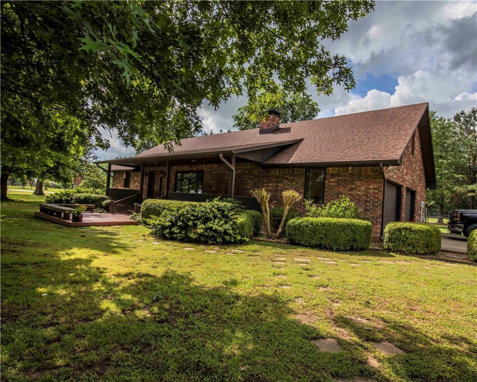 Wow! You don't want to miss this beautiful 2,062 SF home. Hard to find & very well maintained on 10 acres. Fantastic lawn with large shade trees & even walking paths on the property. The home has an open floor plan, custom windows, floors & cabinets. The living room has a large natural stone fireplace with insert, bookcases on both sides, plus a wood theme of wood beams in the ceiling & beautiful wood floors. This same wood theme continues into the kitchen that has an island, gas cooktop, ceramic tile countertops & backsplash, knotty pine cabinets & a stairway leading to an upstairs bedroom. Both the front and back porches are covered, have brick flooring and a nice railing around. The front leads down to an extended wood deck/patio area, while the back has a ceiling fan. Great for entertaining or relaxing after a long day! In addition is a cozy 650+ SF mother-in-law or rental home. There is also a 16X24 storage building with a 10X24 covered side shed with concrete flooring. Lots of extras. This one is a must see!